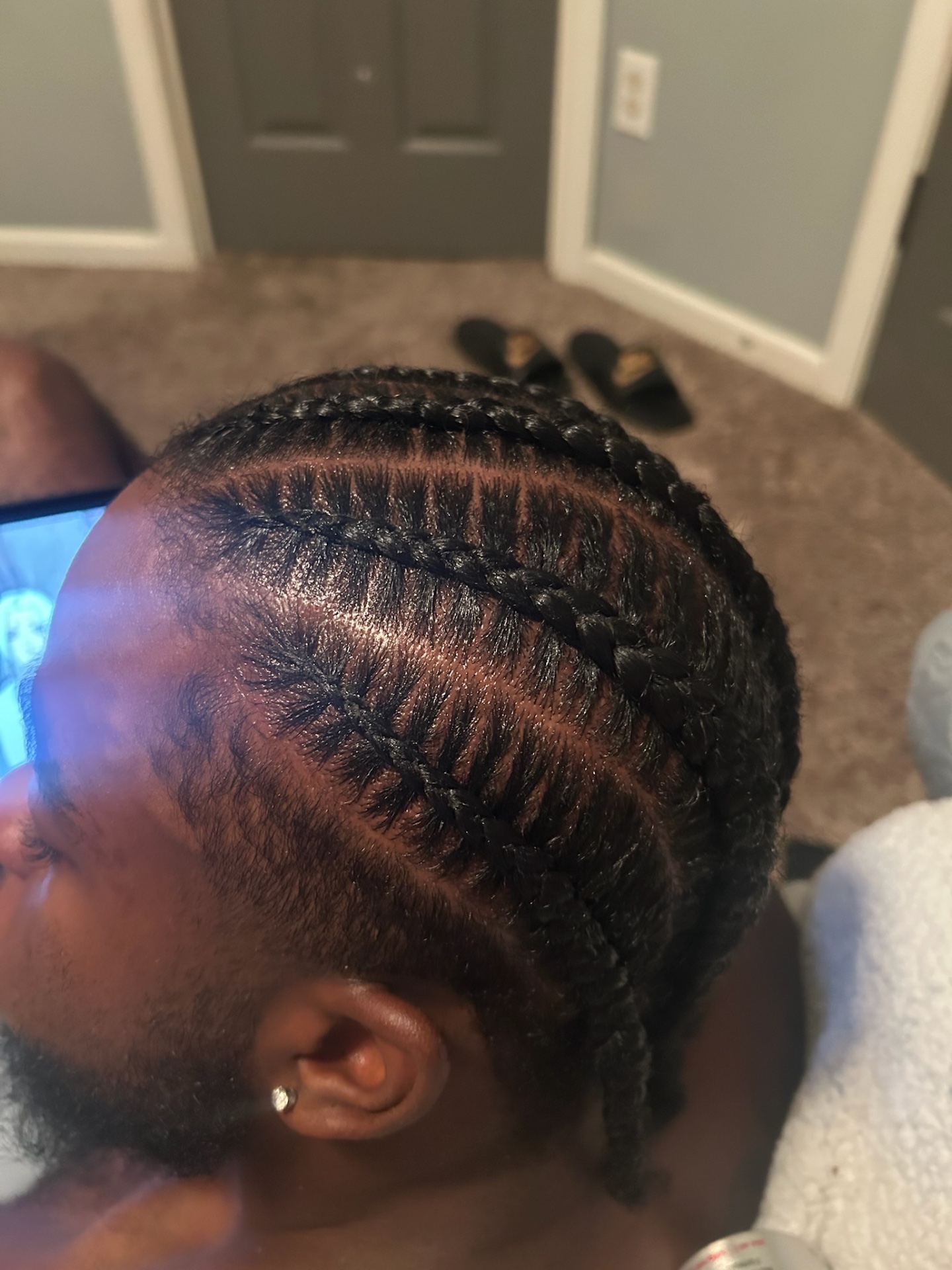 Detailed cornrow braids with precision parting