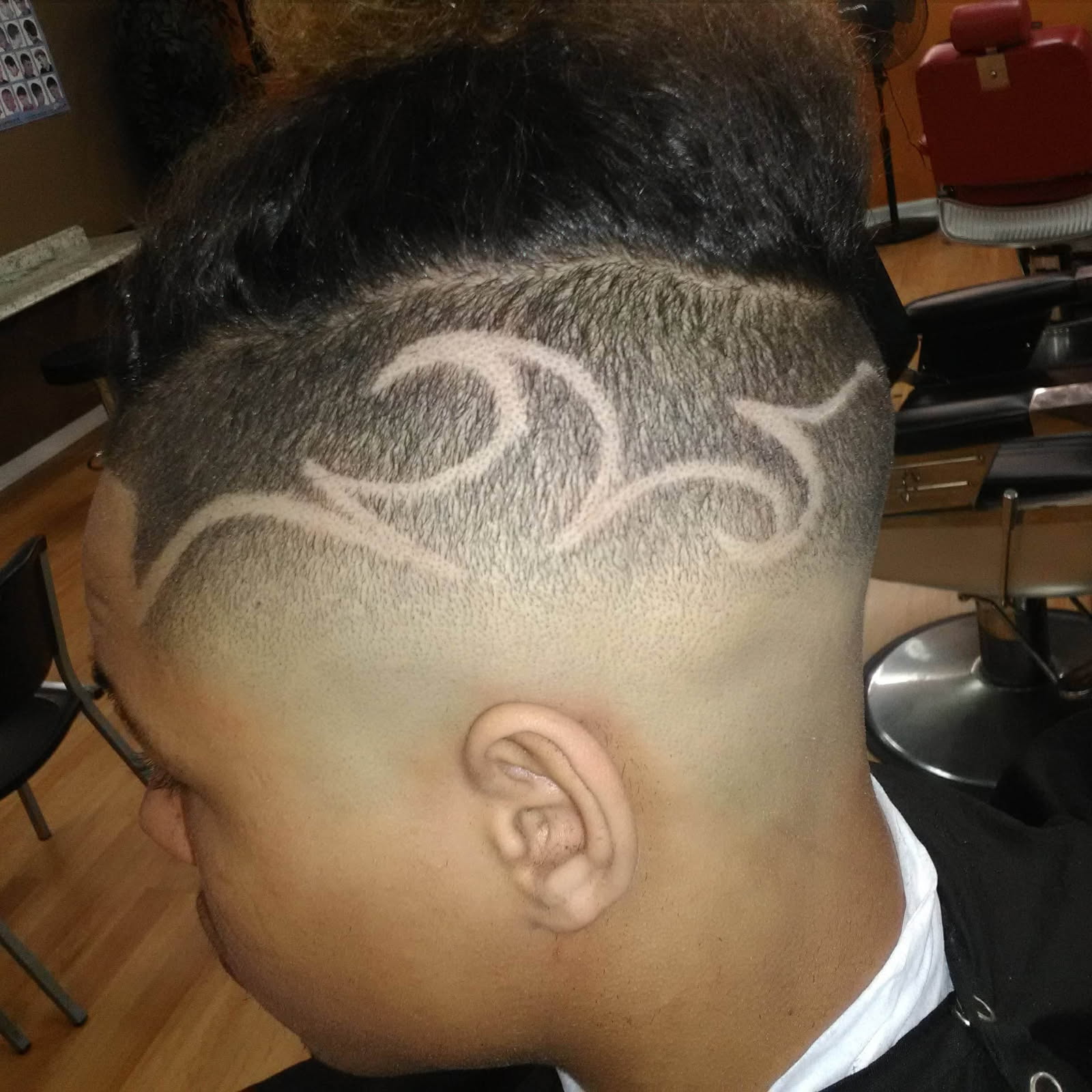 Freestyle tribal hair tattoo design with fade